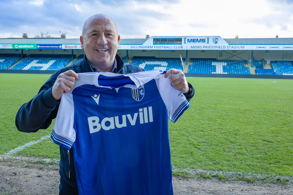 John Coleman holds Gillingham shirt